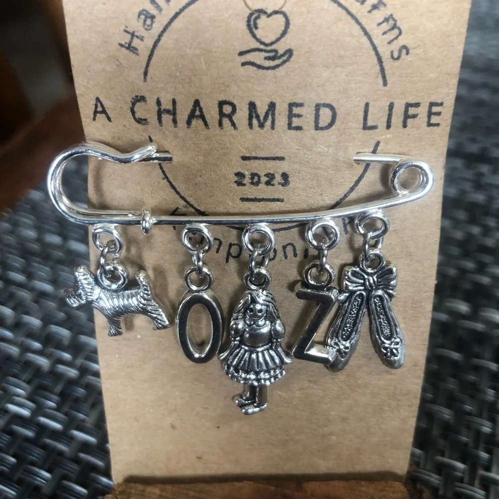 NWT, Handmade by A Charmed Life. Wizard of Oz Silver Charms/Silver 2” Pin